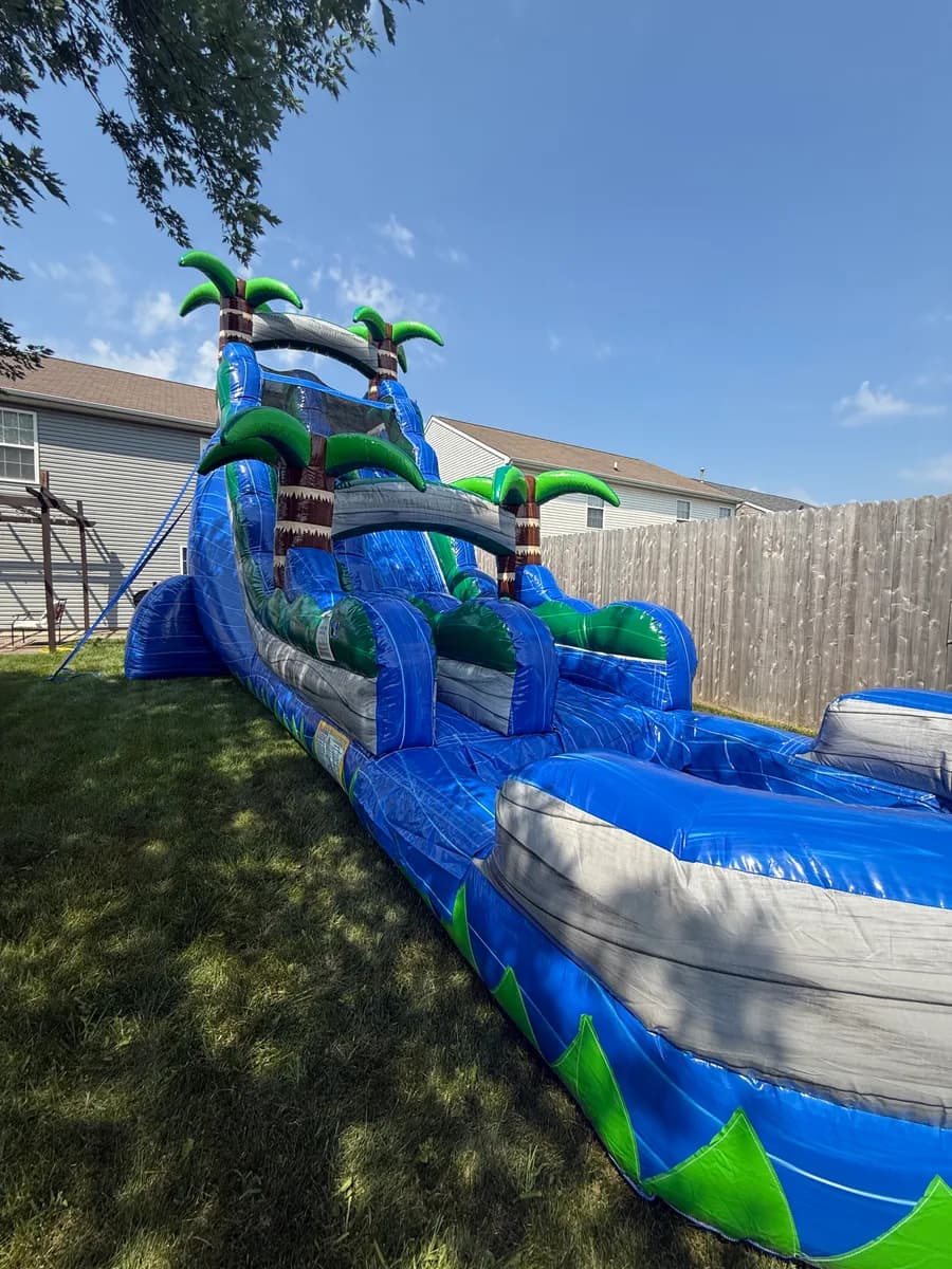 An Alvarez Party Rentals water slide set up in a back yard